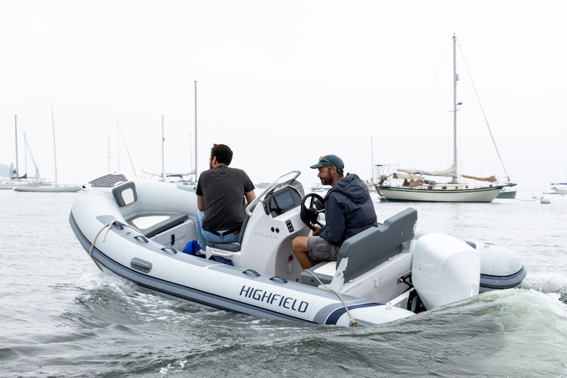 Gabe Pendleton, owner of Pendleton Yacht Yard, and the boat, is at the helm of the new electric boat, ‘Take Charge.’ (Photo courtesy Island Institute)