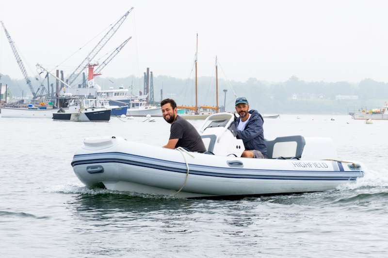 Gabe Pendleton, owner of Pendleton Yacht Yard, and the boat, is at the helm of the new electric boat, ‘Take Charge.’ (Photo courtesy Island Institute)