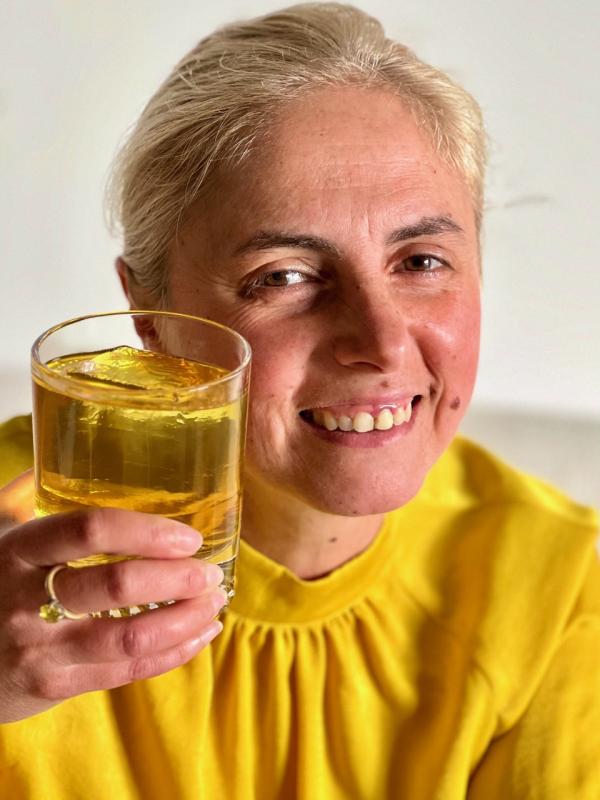 Clementina Senatore, of Paper Plane, with her Camden cocktail lounge’s July “Into the Light” drink featuring bergamot liquor and Oolong tea. Senatore, who came to Maine from Italy nine years ago “by myself, with no family or friends here,” said she stepped up to the Finding Our Voices fundraiser for domestic abuse victims because “I support courage.” (Photo by Patrisha McLean)