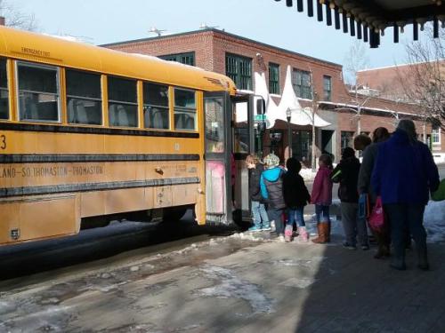 Elementary school students arrive at a Strand educational event