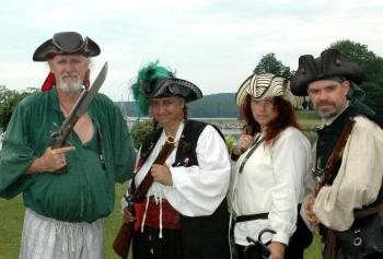 Donna Keniston and Black Rose Privateers: Donna Keniston (second from left), in her role as Capt. Ann Flynte, is flanked by members of her crew, including her husband Charles (left). They were engaging in a weapons demonstration at the 2013 Damariscotta River Pirate Rendezvous. Donna Keniston passed away on Feb. 11, 2014. Courtesy of Ellie Busby