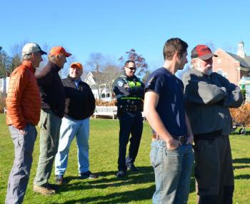 At Harbor Park, selectmen, police and firefighters keep an eye on the march. (Photo by Lynda Clancy)