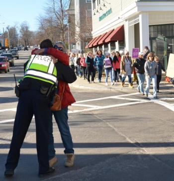 Camden Police Sgt. Allen Weaver Jr. gets a hug from a ctizen. (Photo by Lynda Clancy)