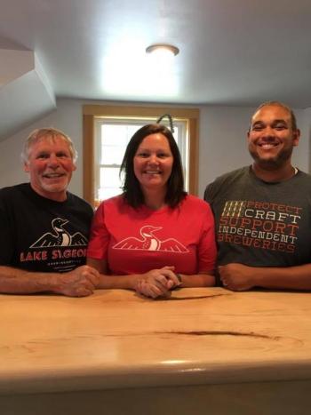 It’s a family operation! From left: Danny McGovern, Elizabeth Johnston, and Jeff Johnston at the tasting bar at Lake St. George Brewing. (Photo: Jenna Lookner)