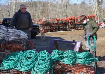 Rockport fisherman Kenneth Dodge and one of his sternmen, Damian Weaver, with all the lines to which purple paint needs to be applied. (Photo by Lynda Clancy)