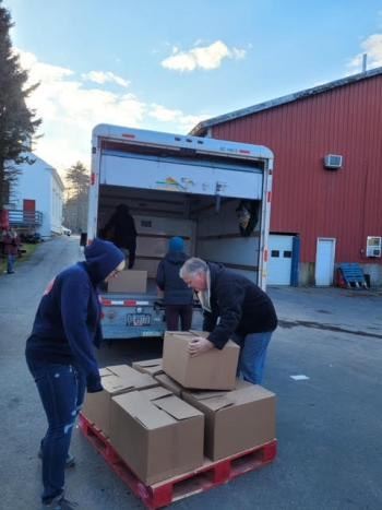 Belfast Lions and high school LEOs load up a panel truck with Thanksgiving boxes to transport to Belfast prior to the delivery day. (Photo by John Lynam)