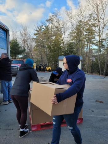 LEOs load Thanksgiving boxes at the Wentworth store in Brooks. (Photo by John Lynam)