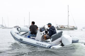 Gabe Pendleton, owner of Pendleton Yacht Yard, and the boat, is at the helm of the new electric boat, ‘Take Charge.’ (Photo courtesy Island Institute)