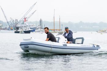 Gabe Pendleton, owner of Pendleton Yacht Yard, and the boat, is at the helm of the new electric boat, ‘Take Charge.’ (Photo courtesy Island Institute)