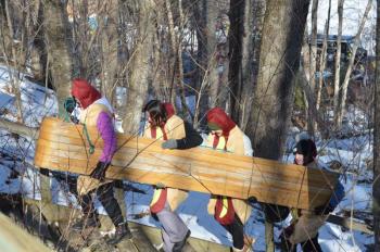 No matter how fit and trim the crew might be, the walk up the stairs to the top of the chute is always a test of team’s mettle. But then, the ride back down is a fury of adrenaline and an exciting blast across the icy pond.