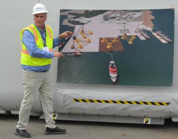 Sprague’s Vice President of Materials Handling James Therriault illustrates the Mack Point plan with a rendering of the site that would front Penobscot Bay. (Photo by Lynda Clancy)