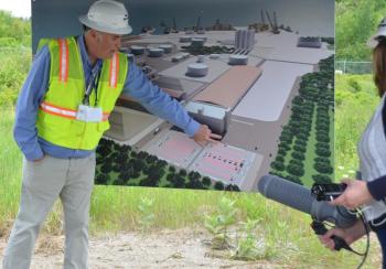 Sprague’s Vice President of Materials Handling James Therriault illustrates the Mack Point plan with a rendering of the site. The perspective is from a small hill on the inland portion of Sprague’s Searsport land. (Photo by Lynda Clancy)