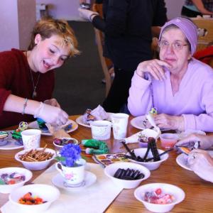 Clara Snow, left, and Judy Lewis work on decorating some cupcakes together. (Photo Courtesy Of Charles Hamm)