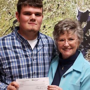 MCST student, Alden Wadsworth, left, accepts a check from Maine Lobster Festival director, Sharon Lombardo.