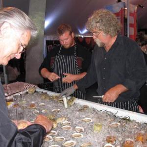 Jeff "Smokey" McKeen churns out freshly shucked Pemaquid oysters as fast as he can while people chose of two types of champagne from “The Bubble Bar” to accompany it. (Photo by Kay Stephens)