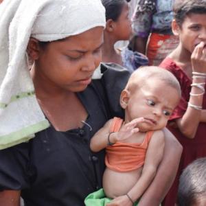A displaced mother holds her malnourished infant. (©2015 Fortify Rights)