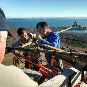 Tom Jackson, Simon Derico and Randy Stearns get the Mt. Battie Star in place high over Camden Harbor and Penobscot Bay, Nov. 19. (Photo courtesy David Walck)