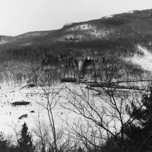 An ‘aerial’ photo that would have been taken between 1937 and 1941 – clearly not an actual aerial shot – it was taken from the mountain across the pond from the Snow Bowl. You can see the original lodge, and the 1937-era toboggan chute nearby. (Courtesy of the Camden Public Library from the book ‘The Camden Snow Bowl: A Historical Documentary 1936-1996’ by Jack Williams)
