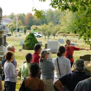 Megan Pinette (facing crowd) leads a tour through Grove Cemetery.
(photo by Erica Thoms)