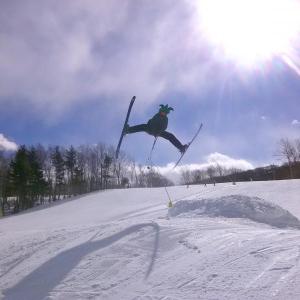 Max Fisher shows skills and hits the jump at the Camden Snow Bowl March 17, St. Patrick’s Day. (Photo by Mike Bonney)