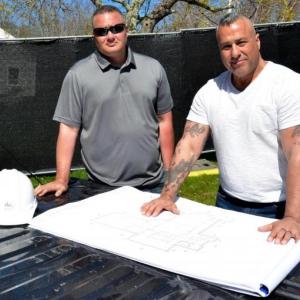 Charlie Frattini, right, on the job with Nate Yeater, building a new library in Rockport Village — a long way from the South China Sea, but yet another challenge. (Photo by Lynda Clancy)