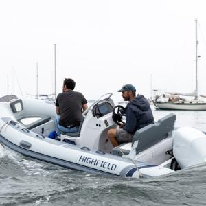 Gabe Pendleton, owner of Pendleton Yacht Yard, and the boat, is at the helm of the new electric boat, ‘Take Charge.’ (Photo courtesy Island Institute)