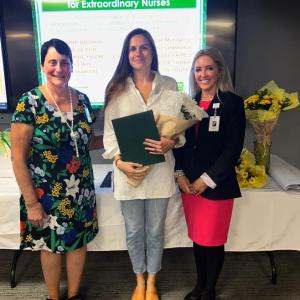 DAISY Award winner Katherine Holm, RN, Emergency Department nurse, stands with PBMC and WCGH Chief Nursing Officer Ellen Leone, RN, left, and PBMC and WCGH President Denise Needham, PharmD, after receiving her award during the DAISY and Sunshine Awards ceremony on Monday, Aug. 21, at PBMC. (Photo courtesy Pen Bay Medical Center)