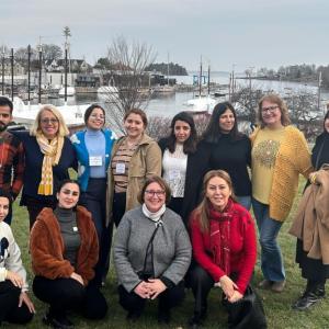 Iraqi domestic violence activists visited with Finding Our Voices in Camden on a State Department-sponsored tour of the United States. Finding Our Voices Founder/CEO Patrisha McLean is second from the left in the back. Finding Our Voices Operations Manager Mary Kamradt is in this same row second from the right. Allison Hodgkins, executive director of the World Affairs Council of Maine, is in the front with the grey sweater. (Photo by Matt LaJoie of the Camden Public Library)