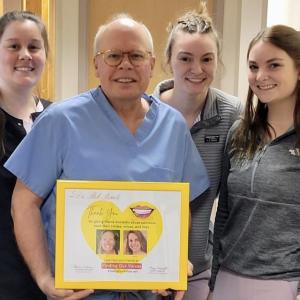Dr. Rob Berube of Facial & Oral Surgery in Augusta with nurses (l-r): Makenzie Hays, MaryAnn McGrath, and Abigail Wright, posing with their "Finding Our Smiles" appreciation plaque. (Photo supplied by Dr. Berube)