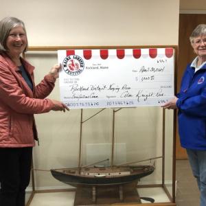 Ann Norman receives accepts the donation on behalf of Rockland District Nursing Association from Sharon Lombardo of the Maine Lobster Festival. (Photo courtesy Maine Lobster Festival)