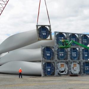 Wind turbine blades have been unloaded at Mack Point from a ship that sailed in from India, and are being stacked in place prior to truck transport to northern and eastern Maine land-based wind power facilities. (Photo by Lynda Clancy)