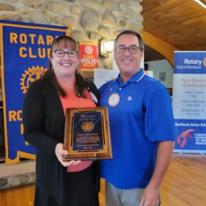 Susan Ware Page is presented with the Rotarian of the Year award by Rockland Rotary president Bob Bird.