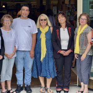From left to right, Rateeba Abu Shosh, Mary Lou Smith, Montaser Abusharar, Patrisha McLean, Suheir Farraj, Mary Kamradt, and Kristy Kilfoyle, the executive director of the Camden Public Library which for two summers in a row has hosted the visit between Finding Our Voices and Middle East women’s rights activists. McLean said that exciting plans for continuing connection between the Palestinian territories and Maine include Palestinian women embroidering items for Finding Our Voices that echo the gorgeous red stitching on the outfit worn by Suheir Farraj, but in the Finding Our Voices signature color of yellow! (Photo courtesy Finding Our Voices)
