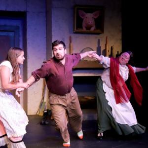 (l-r) Pegeen Mike (Greta Brown) wrestles Christy (Tyler Johnstone) away from The Widow Quin (Emily LeBlanc McConnell) in a scene from "The Playboy of the Western World" by J.M. Synge. (Photo by Gwyneth Sauvage)